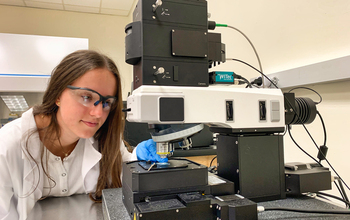 Camila Cabrera operating the Raman microscope in Daniela Radu's Lab at FIU.